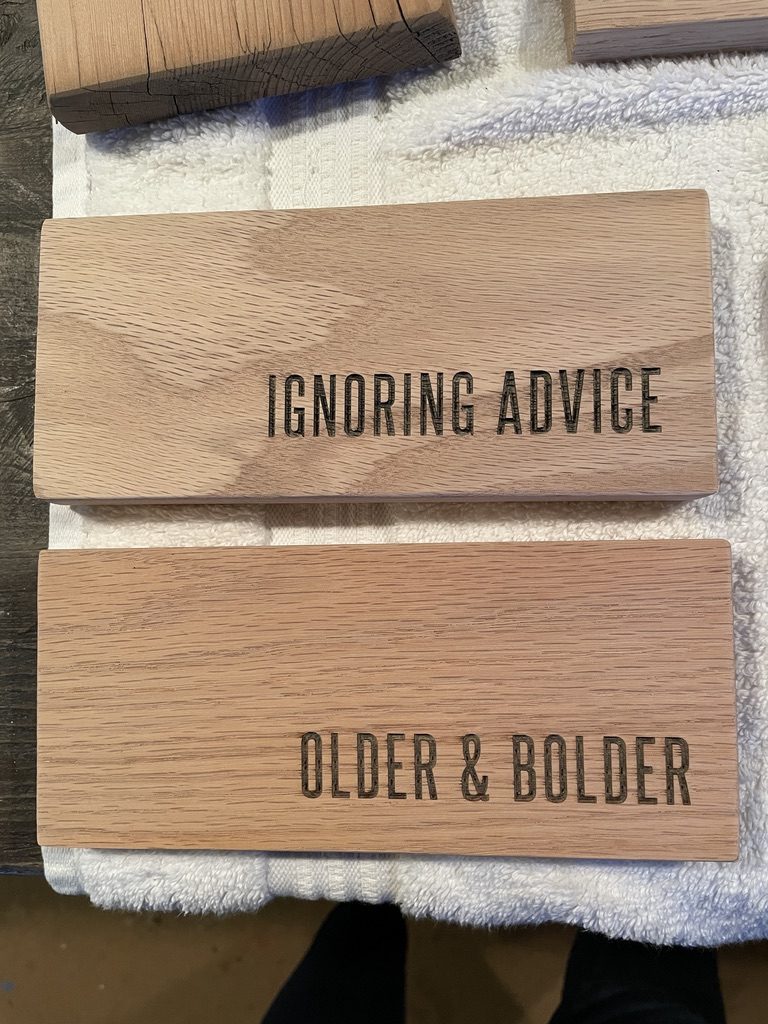 Oak blocks engraved IGNORING ADVICE and OLDER & BOLDER