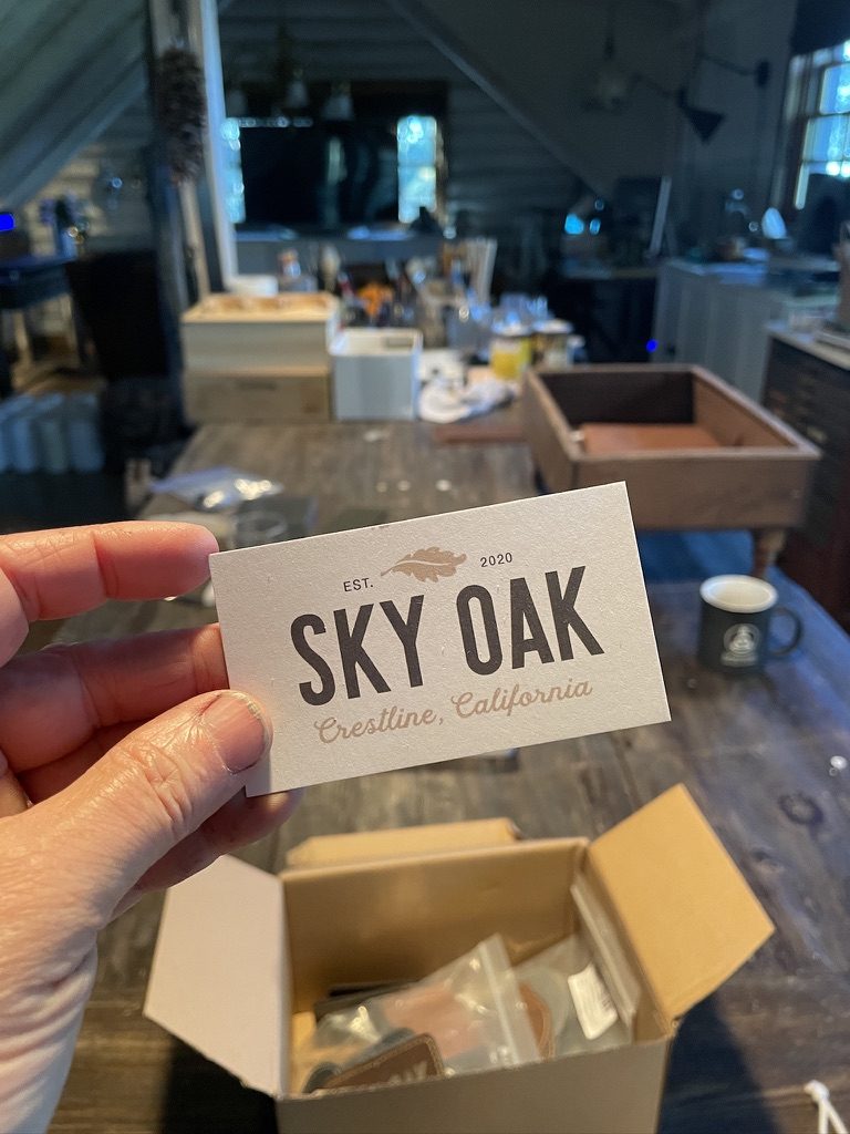 Sky Oak business card held over the workshop table