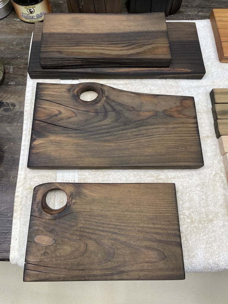 Dark-stained serving boards with natural knot-hole handles