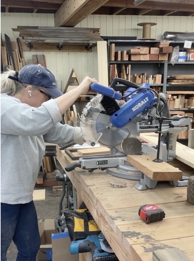 Kristen at the miter saw in her workshop