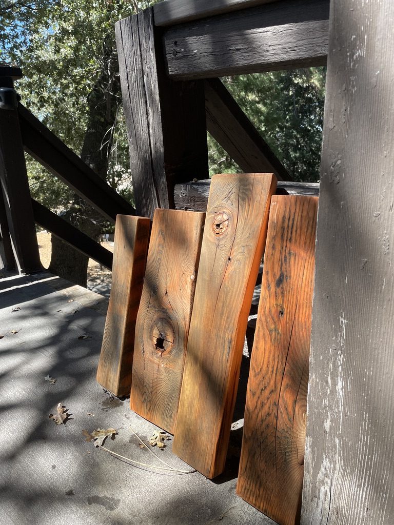 Freshly oiled reclaimed boards glowing orange against deck posts